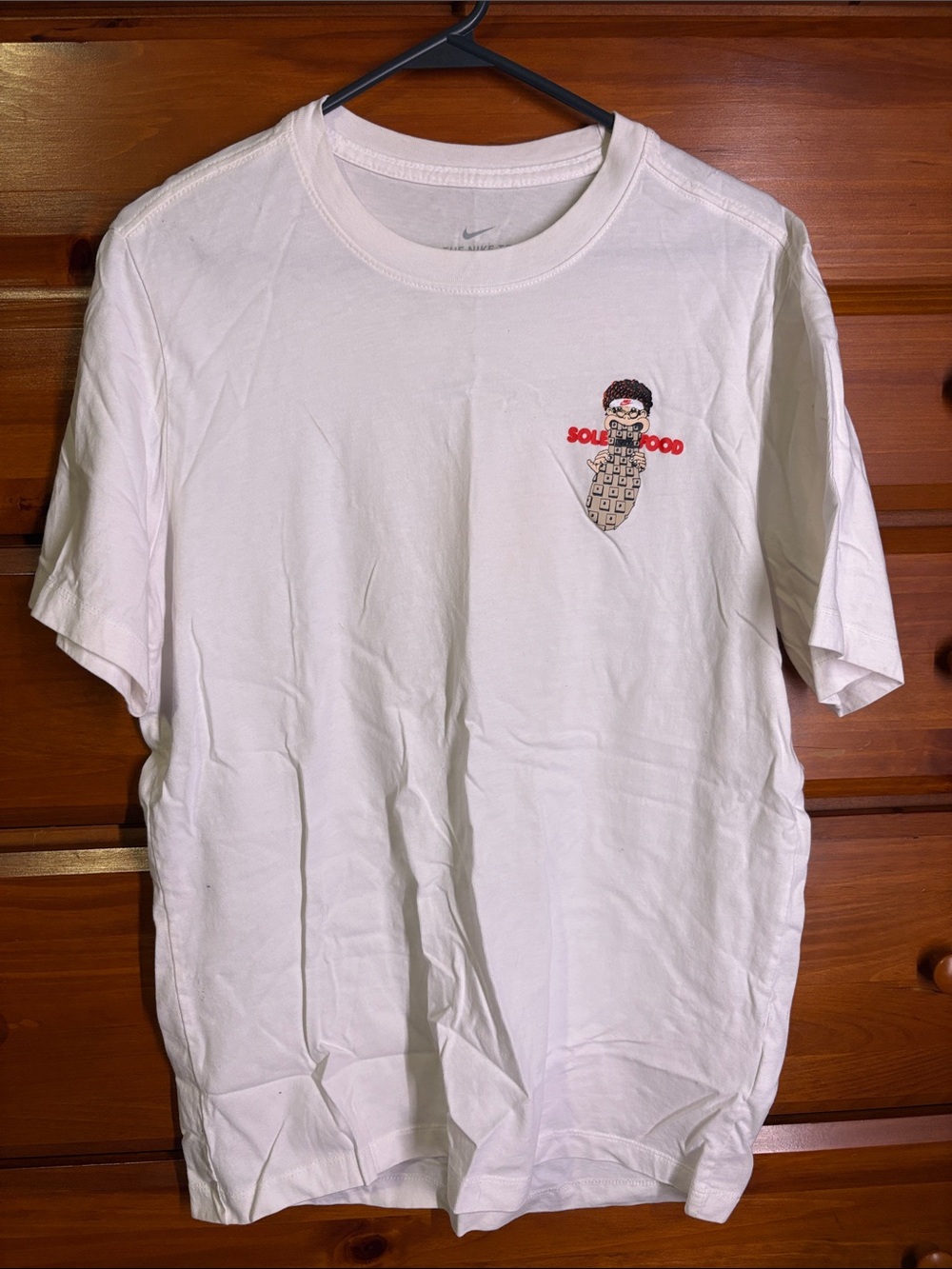Nike White Short-Sleeve Tee with Small Animated Graphic
